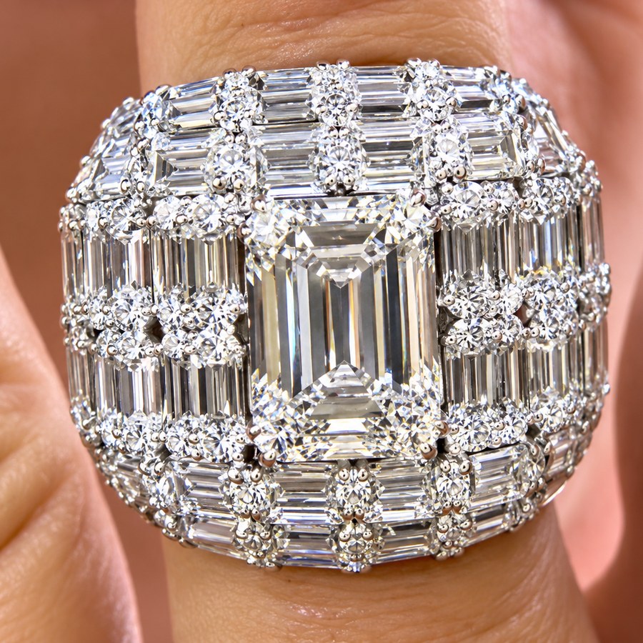 Diamond dome ring with a 10 carat elongated emerald-cut center diamond surrounded by emerald-cut and baguette diamonds