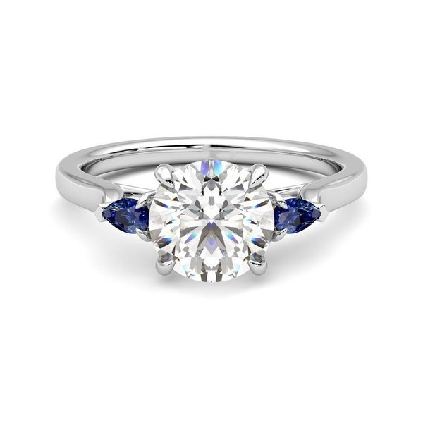 2.5 carat GIA round diamond with pear-shaped blue sapphire sides in platinum