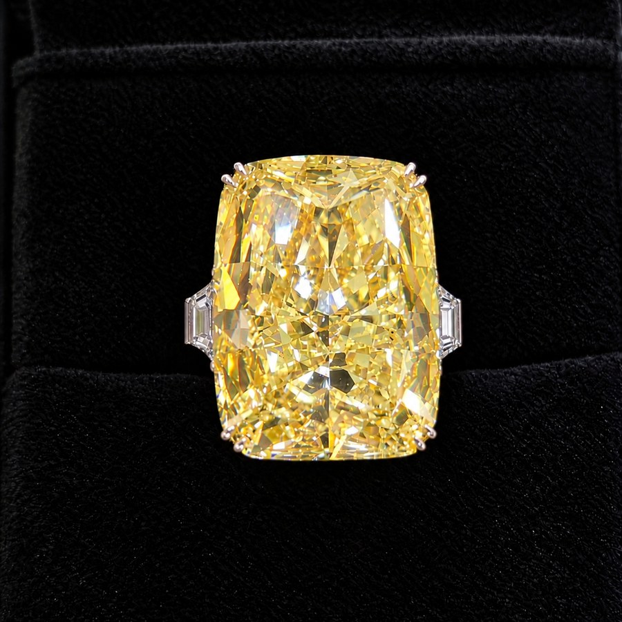 35.50 carat natural Fancy Intense Yellow cushion brilliant diamond ring with trapezoid side diamonds