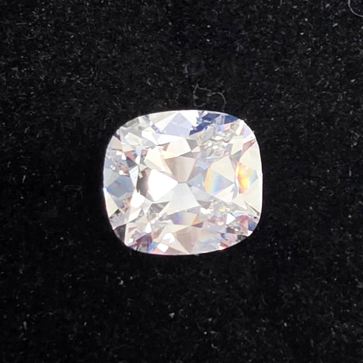 7.24 carat cushion brilliant natural diamond, F color, SI1 clarity, GIA certified, on black velvet
