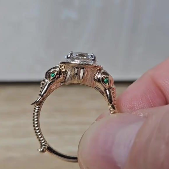 Custom elephant engagement ring in rose gold, side view showing emerald eyes