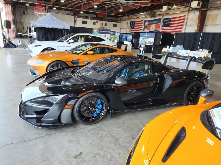 Supercars on display in the hangar at The Elite of New York show