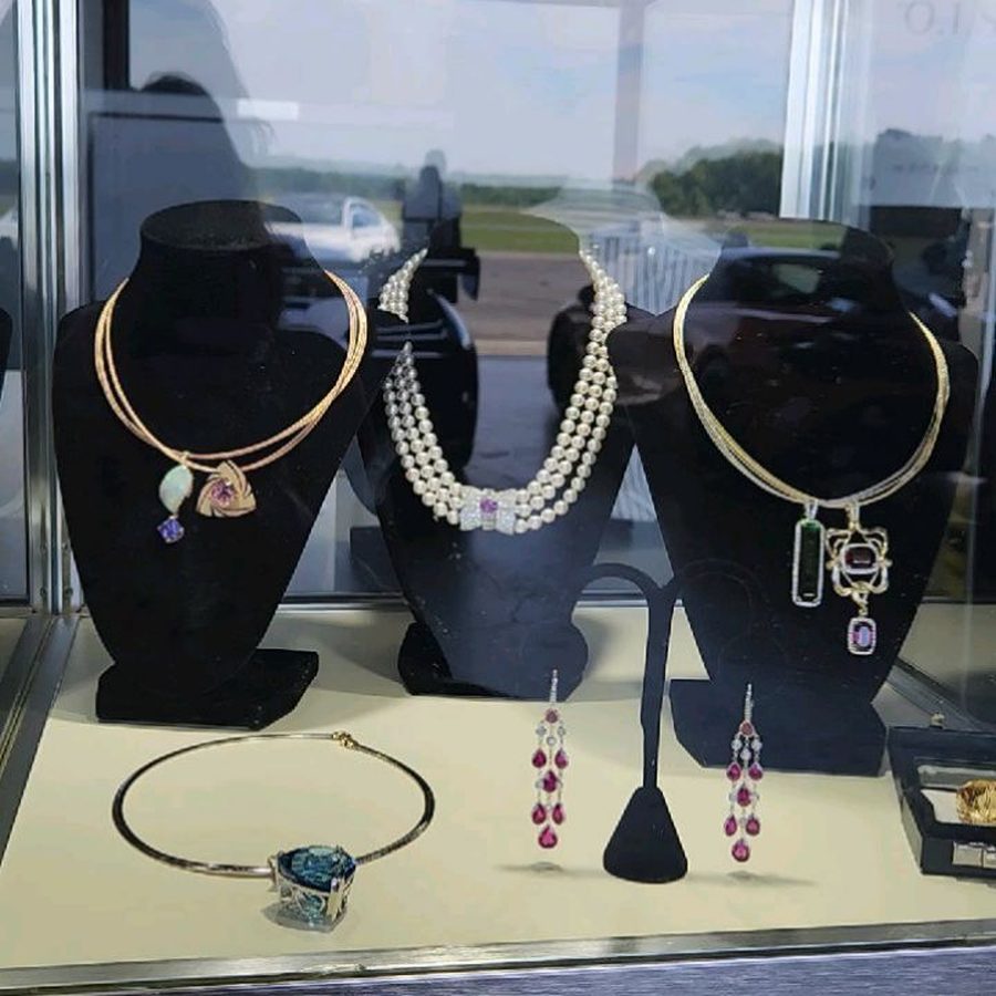 MM Fine Jewelry and Gems display case at The Elite of New York luxury show: pearl, tourmaline and jadeite pieces