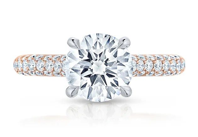 Round brilliant diamond solitaire engagement ring with a pavé band in rose gold and platinum