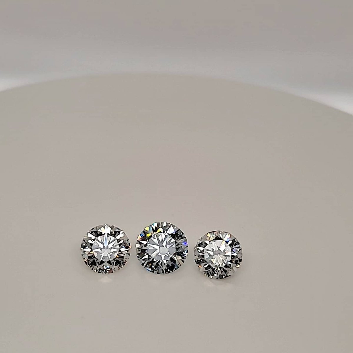Three lab-grown diamonds of about 3 carats each