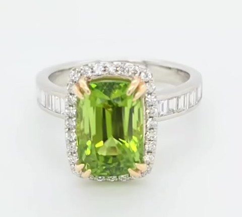 5 carat Burmese peridot ring with diamond halo and baguettes