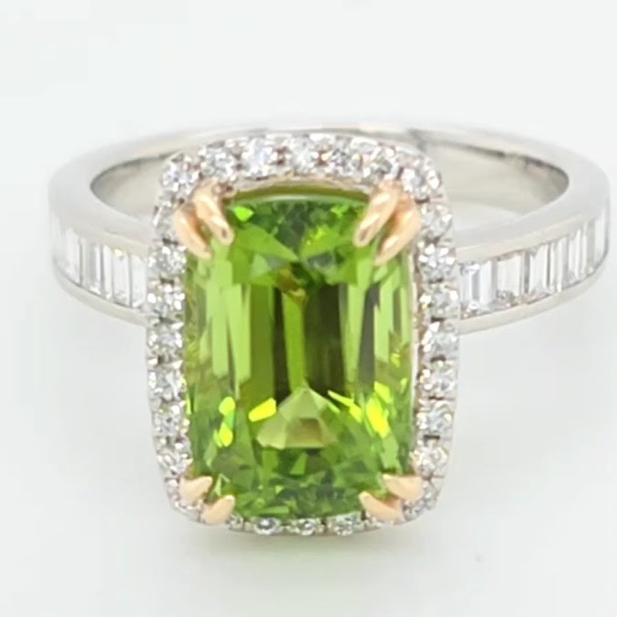 5 carat Burmese peridot ring with diamond halo and baguettes