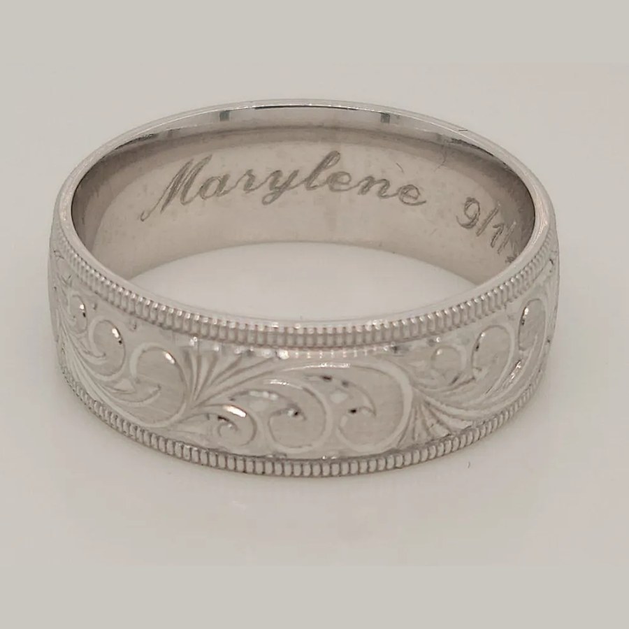 Custom platinum wedding band with hand-engraved scroll pattern, milgrain edges and a personal engraving inside