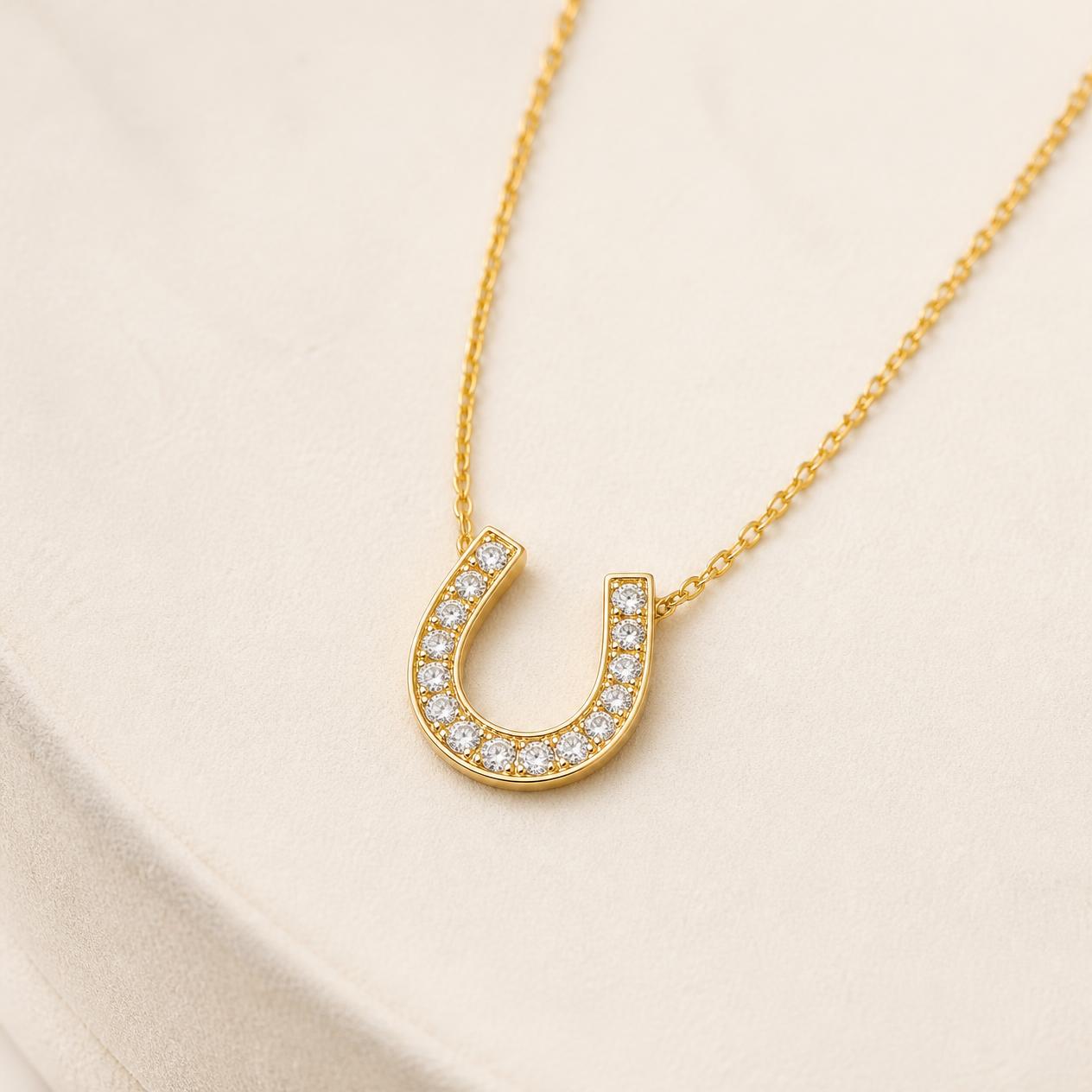 Yellow gold horseshoe pendant pavé set with diamonds on a fine chain