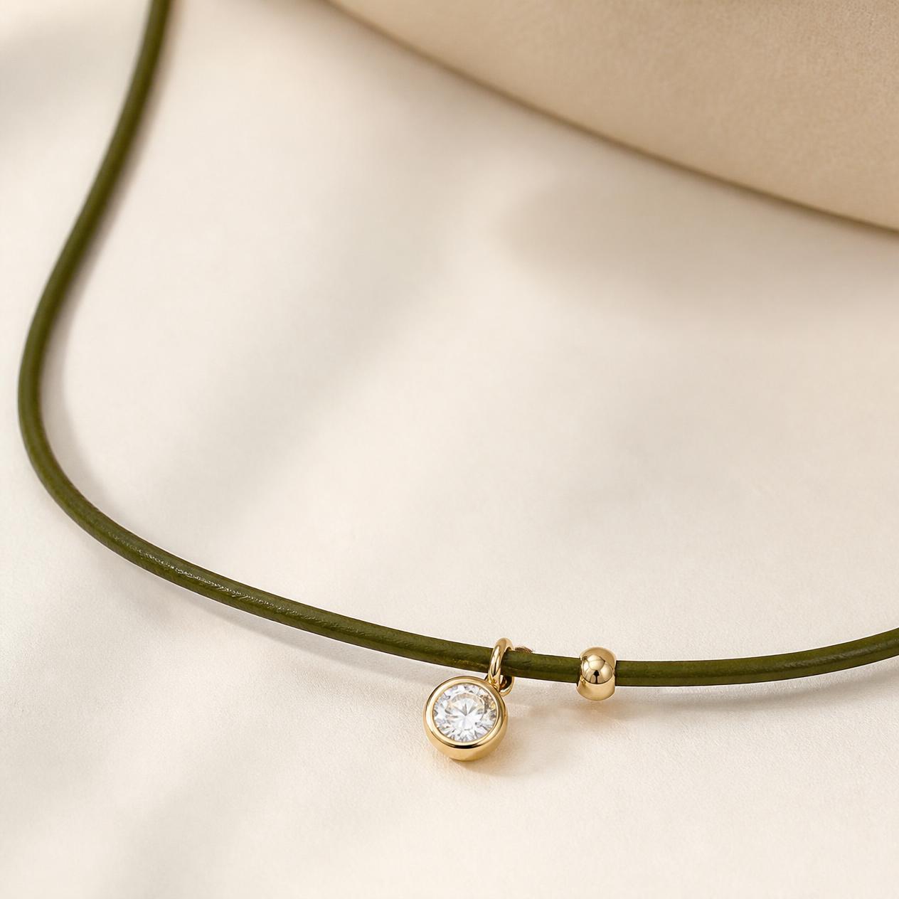 Olive leather cord necklace with a single bezel-set diamond charm in gold